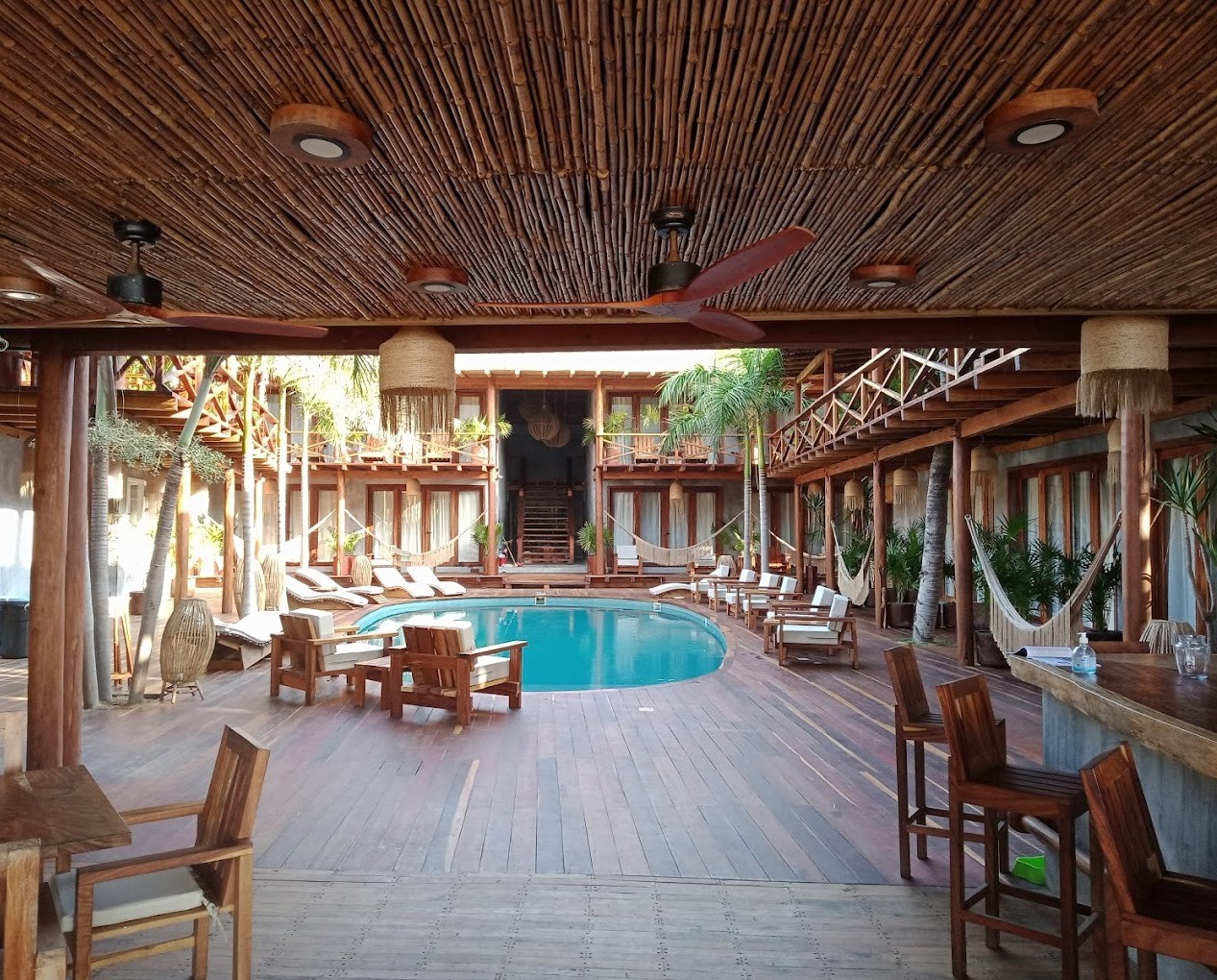 naked_zipolite_oaxaca vista del interior del hotel Naked con piscina y toda la decoración en madera en Zipolite, Oaxaca